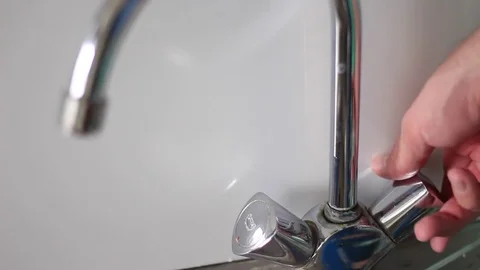 Opening a tap with hot and cold water Stock Footage 71071224