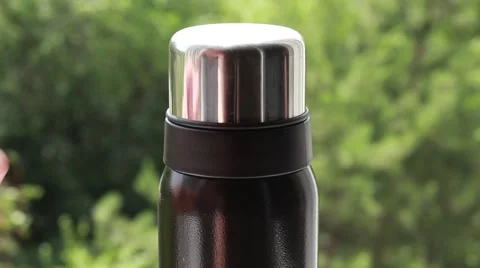 Opening a thermos while picnic Stock Footage 64623030