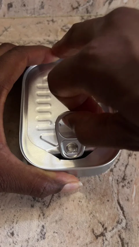 Opening a tin of sardines Video stock 303192946