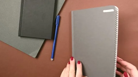 Opening a trendy notebook on brown background for paper design. Stock Footage 166353597