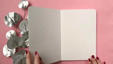 Opening a trendy notebook on pink background for paper design. Stock Footage 165102172