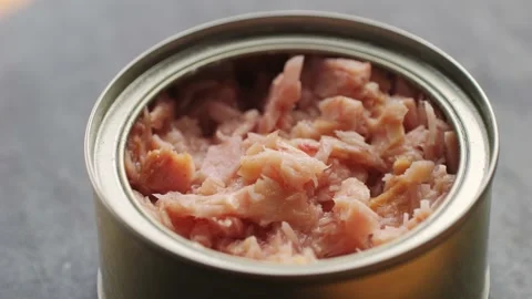 Opening tuna can, man open the canned tuna on the table. Close up on Stock Footage 236483314