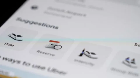 Opening Uber app on a smartphone, selecting destination and ride options Stock Footage 295170591