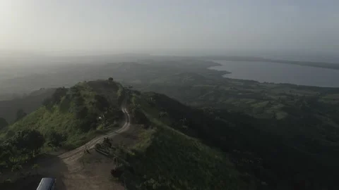 Opening view to green mountains with a road and lake background Stock Footage 142171244
