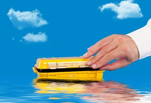 Opening a water resistant case floating in the water Stock Photos