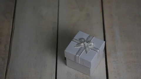 Opening white gift box with red heart inside over white wooden background Stock Footage 85495066