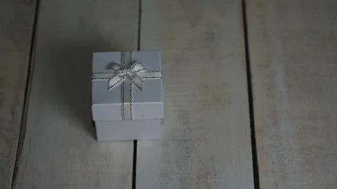 Opening white gift box with red heart inside over white wooden background Stock Footage 85495338