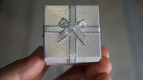 Opening white gift box with red heart inside over white wooden background Stock Footage 85495762