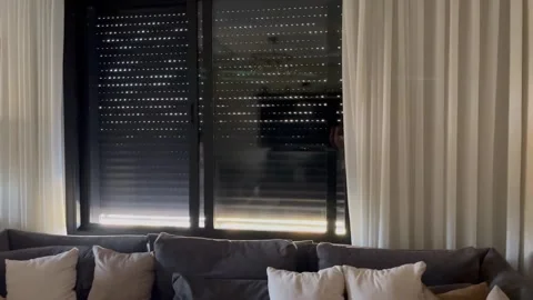 Opening Window Roller Shutters in a Living Room Video stock 345741045
