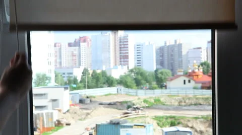 Opening window with scroll roll blinds, with view of building 動画素材 64384216