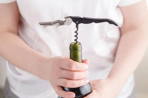Opening wine bottle with a corkscrew Stock Photos