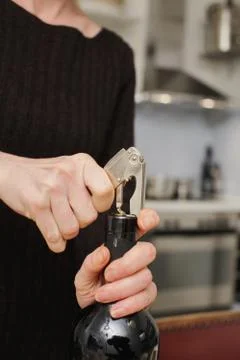 Opening a wine bottle Stock Photos