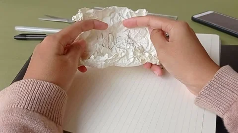 Opening a wrapped up paper in the workplace Stock Footage 150523584