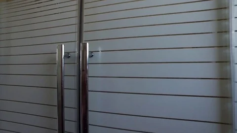 Opens and closes doors in the shower room Stock Footage 78215145