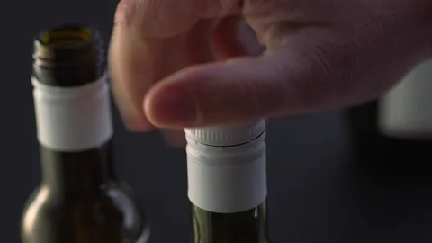 Opens a bottle with a screw cap. Stock Footage 261985136