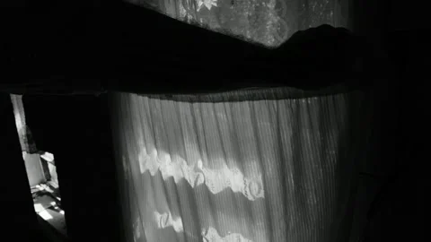 Opens the curtain on the window of the old house Stock Footage 143258825