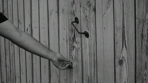 Opens the gate and enters, black and white Stock-Footage 116477482