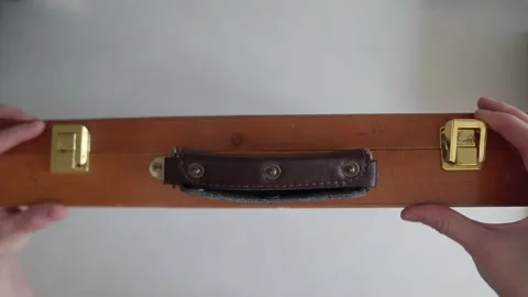 Opens an old wooden suitcase Stock Footage 169835183