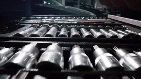 Opens a pull-out cabinet containing a set of tools for repairing a car Stock Footage 340580953