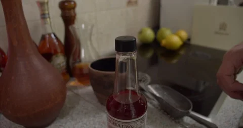 Opens the sauce and drips several times into the shaker Stock Footage 130051866