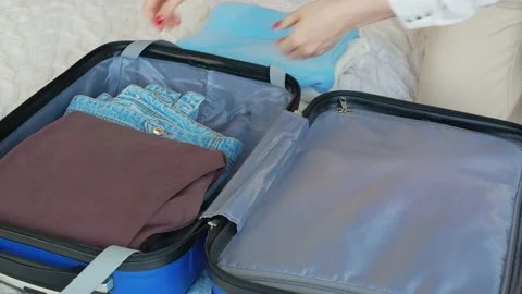 Opens the suitcase. View of a woman's hand opening a suitcase, sorting things Stock Footage 147086593