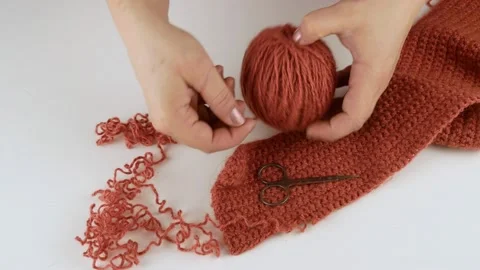 Opens the yarn and winds it into a ball. Crochet pattern of threads. Stock Footage 141424642