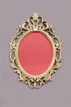 Openwork oval golden colored frame on wall Foto stock