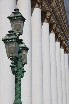 An openwork street lamp in front of the columns of the Bolshoi Theater buildi Stock Photos