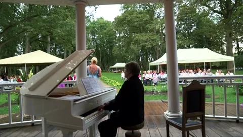 Opera singer and pianist performs on the terrace of an ancient manor Stock Footage 238934413