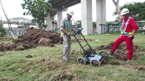 Operate a land metal detector machine, supervised by a safety officer. Stock Footage 159603681