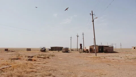 Operating and abandoned buildings next to electrical panels and semi-trailers in Stock Footage 236750655