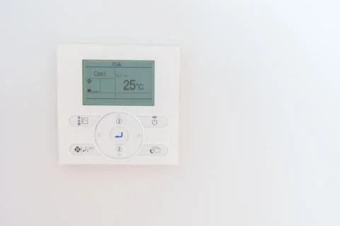 Operating and adjusting Air conditioner temperature remote control in home... Stock Photos