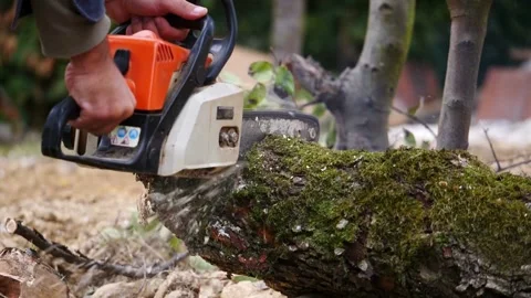 Operating Chainsaw Blade of a Man Close Up In Action with Saw Dust Flying 動画素材 336570980