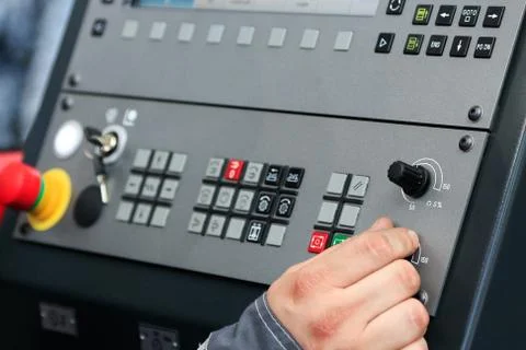 Operating the controls of CNC machine Stock Photos