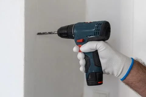 Operating cordless drill for installation tasks in home improvement project Stock Photos