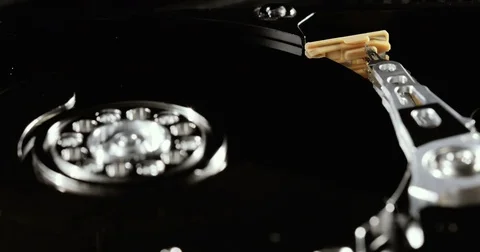 Operating hard disk drive on dark background. HDD reading and writing data. Stock Footage 78790963