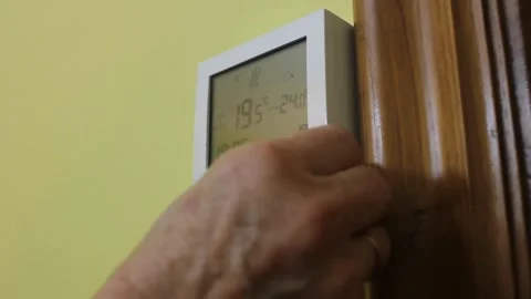 Operating a heating thermostat at home Stock Footage 322026870