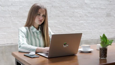 Operating her computer at a cafe, a young woman from Ukraine earns a living Stock Footage 245258599