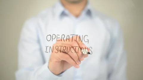 Operating Instructions, man writing on transparent screen 스톡 사진