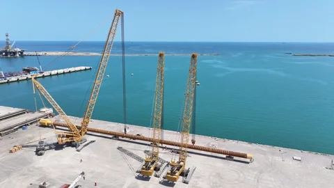 Operating large cranes and pipes on a deepwater rig Stock Footage 280360968