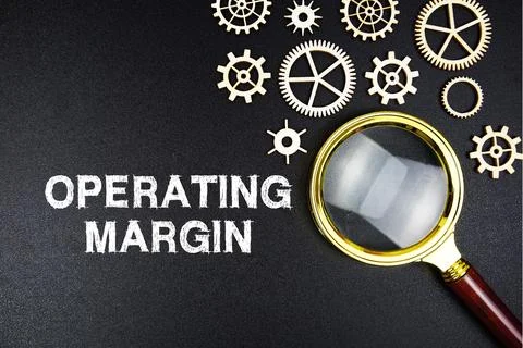 Operating Margin text message with magnifying glass on black background Stock Photos