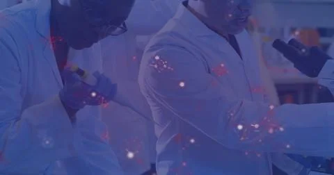 Operating micropipette, two scientists wearing white coats working in lab with Stock Photos