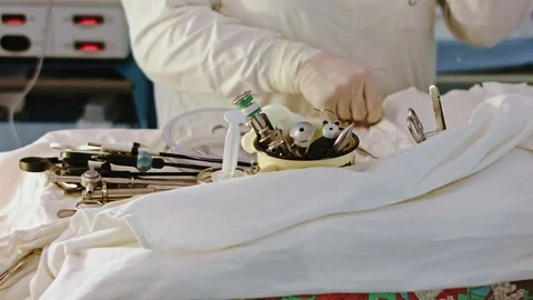 Operating. A nurse prepares the tools for surgery. Stock Footage 77397603