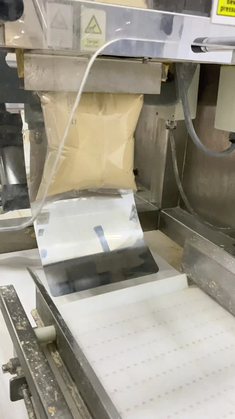 Operating a Packaging Machine in a Clean Industrial Setting Stock Footage 333307077