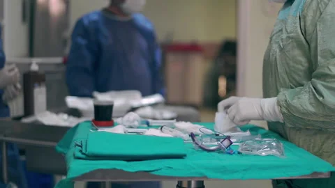 Operating Room and surgeons preparing for a surgery Stock Footage 242414915