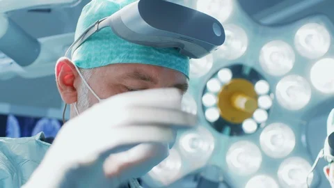 In Operating Room Closeup Surgeon Puts on VR Glasses Starting to Ope Stock Footage 89648524