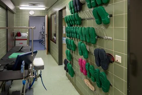 On  operating room corridor there is a wall with surgical shoes for the staff Stock Photos