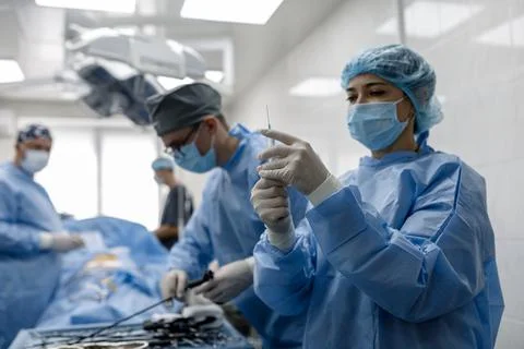 Operating room doctors perform an injection operation Stock Photos