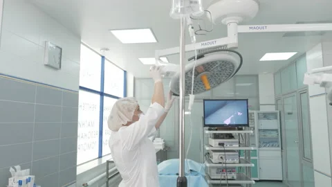 Operating room during surgery. All the lights turned on. The surgeons performing Stock Footage 143159535