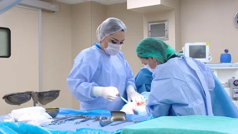 Operating room for maternity ward.Surgeon performing cesarean section.  Stock-Footage 75429773